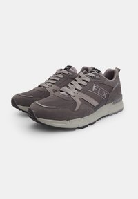 Gray athletic shoes made of leather and mesh, featuring a padded collar, lace-up design, and contrasting white sole with a prominent logo.
