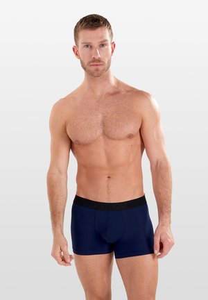 Boxer-briefs navy avec une taille élastique noire portant le logo "HOM". Fabriqués à partir d'un tissu lisse et extensible, offrant un ajustement confortable.