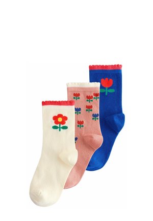 Three pairs of cotton socks: white with a red flower, pink with multi-colored flowers, and blue with a red flower. All have scalloped tops.