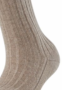 Calzino marrone a costine con un motivo textures, materiale morbido e tallone rinforzato. Il design presenta strisce verticali e una finitura liscia.