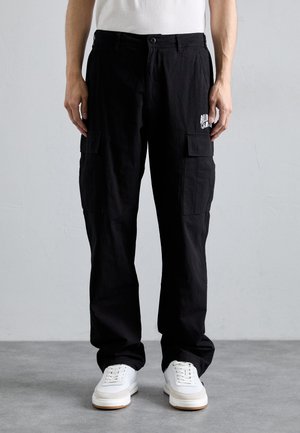 Black cargo pants made of lightweight fabric with two side pockets, a logo on the right thigh, and a straight-leg design.