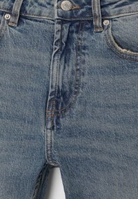 Lichtblauwe spijkerbroek met een hoge taille, voorzien van een subtiele vervaging, contrasterende stiksels en een knoopsluiting aan de voorkant. Inclusief standaardzakken.