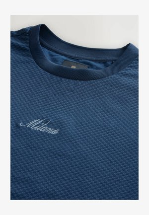 Navy blue textured T-shirt with a round neckline and a ribbed collar. Features an embroidered "Milano" in lighter blue thread.
