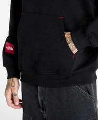 Sudadera negra con un bolsillo canguro, costuras de acento rojas y una etiqueta de logo de la marca roja en la manga izquierda. Puños y dobladillo acanalados.