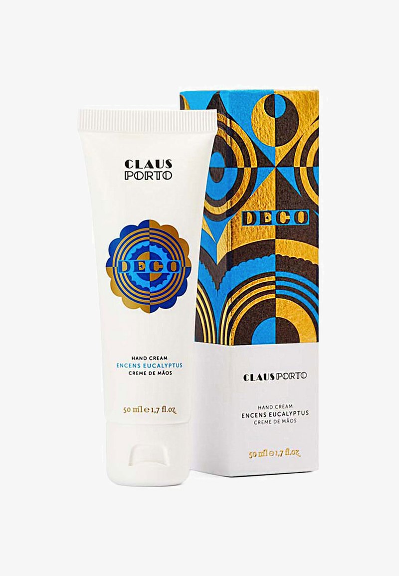 Handcreme-Tube in Weiß mit kreisförmigem blauen und goldenen Design; die Verpackung zeigt kräftige geometrische Muster in Blau, Gold und Schwarz. 50 ml Größe.