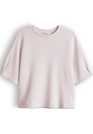 Light pink short-sleeve knit top with a round neckline and raglan sleeves, displayed flat on a white background.