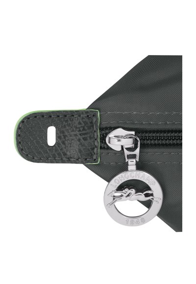 Gray fabric exterior with a textured leather tab. Features a shiny silver zipper and a circular metal charm with a horse logo.