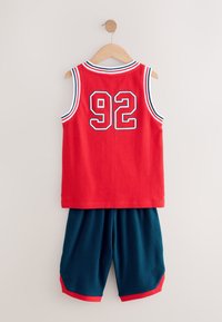 Red mesh sports jersey with blue and white accents, featuring the number 92. Teal mesh shorts with red trim hang below the jersey.
