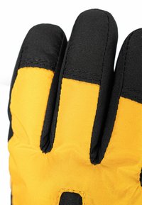 Black and yellow padded glove with a textured surface, featuring outlined fingers and a seam running along the edges for durability.