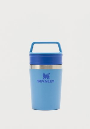 Blue Stanley insulated travel mug with handle on lid and stainless steel band near top, isolated on white background.