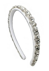 White fabric headband adorned with clear rhinestones, incorporating various shapes and sizes along one edge for decorative detail.