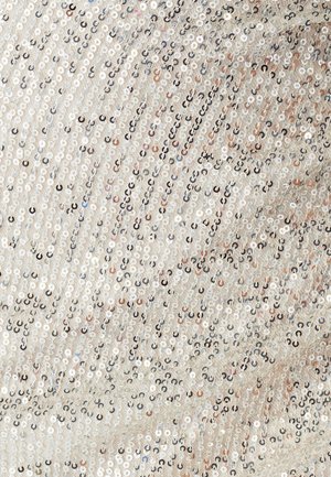 Silver sequined fabric featuring a shimmering pattern with varying sizes of sequins in shades of silver, with some light brown accents.
