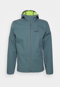 Giacca softshell in teal con cappuccio, caratterizzata da un interno verde brillante, zip frontale e due tasche laterali. Logo Jack Wolfskin visibile.