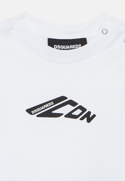 Vit bomullströja med en svart grafisk logotyp, "DSQUARED2 ICON," och tryckknappar på axeln för extra detalj.