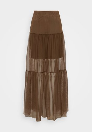 Ruda sluoksniuota sijonas su tekstūriniu tinkleliu ir elastinga juosmena. Yra trys sluoksniai permatomo audinio, suteikiantys lengvą siluetą.