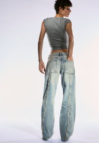 Bershka LOW WAIST WITH FRINGING  - Baggy džíny - light blue denim