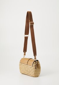 Woven straw handbag with a tan leather flap and brown adjustable strap. Features gold-tone hardware and a rounded rectangular shape.