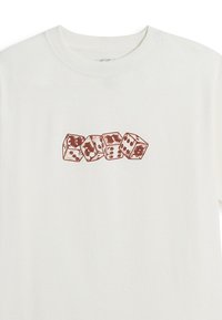 White T-shirt with four brown dice spelling "RANS" in Gothic font across the chest.