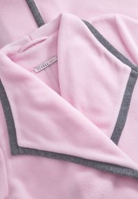 Pink fleece bathrobe with gray trim, featuring a shawl collar and a soft texture. Brand label "Feraud Paris" visible inside.