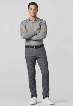 Gray long-sleeve polo shirt with a three-button placket, paired with navy checkered slim-fit trousers and white sneakers.
