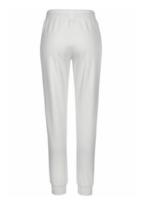 White cotton sweatpants with an elastic waistband, tapered legs, and ribbed cuffs. Smooth texture, no patterns or accents visible.
