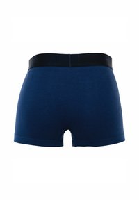 Boxers en coton bleu marine avec une ceinture élastique noire et un petit détail fente à l'arrière, présentant une texture lisse et une coupe ajustée.