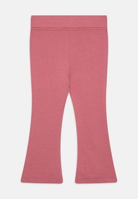 Leggings cor-de-rosa com efeito fluido, feitos de um tecido suave e texturizado. Apresentam uma cintura elástica e bordas costuradas. Superfície lisa e sem adornos.
