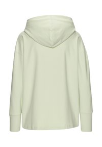 Felpa verde chiaro con una vestibilità ampia, maniche lunghe e un cappuccio grande. Realizzata in tessuto morbido con una trama liscia.