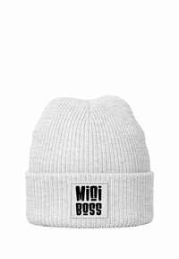 White knitted beanie with ribbed texture and folded cuff. Features a rectangular label with the text "Mini Boss" in bold black letters.