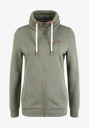 Grüne Zip-Hoodie aus weichem Material, mit hohem Kragen, cremefarbenen Kordeln, Seitentaschen und kleinem Logo auf der Brust.