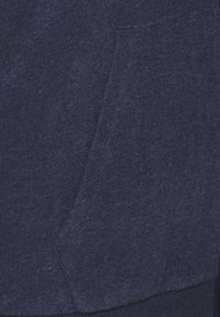 Marineblaue Sweatshirt-Stoff mit einer weichen Textur, ausgestattet mit einer seitlichen Tasche und gerippten Bündchen. Das Material wirkt leicht und atmungsaktiv.