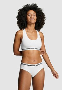 White sports bra and matching bikini briefs with black Puma logo on elastic bands. Smooth fabric with a fitted design and wide straps.