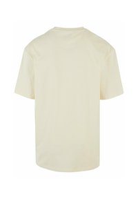Short-sleeve, crew-neck T-shirt in cream cotton, featuring a relaxed fit and smooth texture with a straight hem and no visible logos.