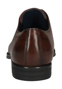 Brauner Lederschuh mit abgerundetem Absatz und schwarzer Gummisohle. Verfügt über dezente Nähte und ein dunkelblaues Innenfutter.