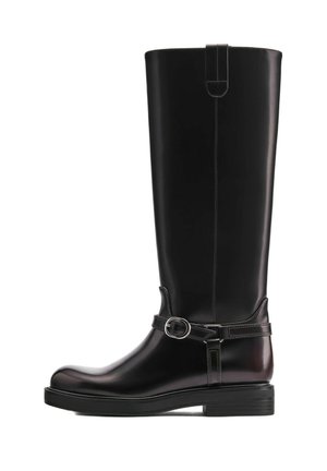 Tall black leather boot with round toe, low stacked heel, and decorative strap with silver buckle around ankle.