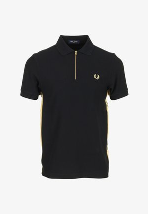 Polo noir à manches courtes avec des bandes latérales dorées, une fermeture éclair dorée au col, et un petit logo laurier doré sur la poitrine gauche.