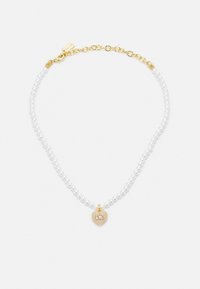 White pearl necklace with a gold chain. Features a heart-shaped charm with a "C" initial, combining smooth and textured elements.