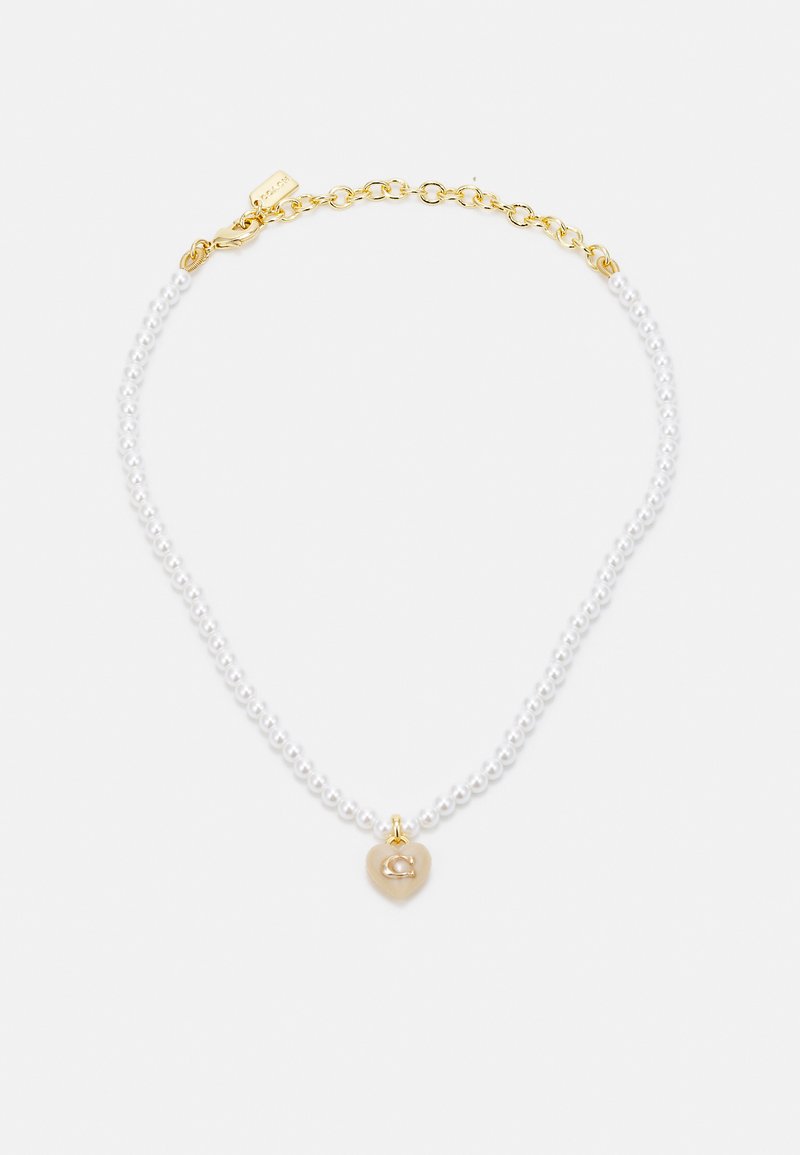 White pearl necklace with a gold chain. Features a heart-shaped charm with a "C" initial, combining smooth and textured elements.