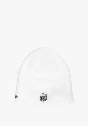 White knit beanie with a rounded top, featuring a green NFL logo patch on the front and subtle texture throughout the fabric.
