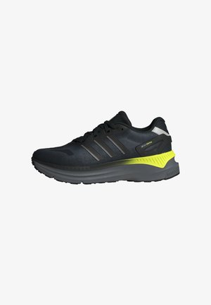 Baskets de course Adidas ZX RS en noir et gris foncé avec un accent vert lime sur la semelle intermédiaire et des lacets noirs, présentées en vue de profil gauche.