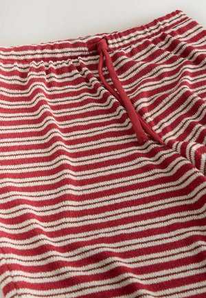 Red and white striped knit pants with elastic waistband and red drawstring tie on a white background.