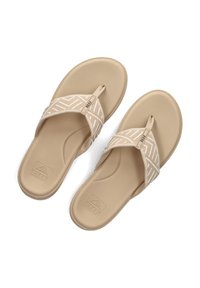 Beige slippers met gestructureerde banden met een wit zigzagpatroon, gemaakt van rubbermateriaal, met een glad, gevormd voetbed.