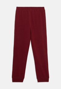 Bordeaux sweatpants met een elastische tailleband, tapered benen en ribgebreide boorden; zachte stof met een gladde textuur.