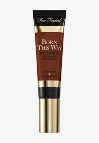 Too Faced Born This Way Soft Matte Oil Control Foundation in a dark brown tube with gold and black accents, featuring a pump dispenser.