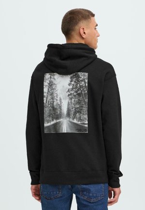 Black hoodie made of cotton, featuring a photographic print of a snowy road with trees on the back. Ribbed cuffs and hem.