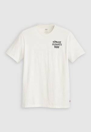 T-shirt di cotone bianco con maniche corte, caratterizzata da testo nero "HOUSE PLANTS" e logo "Levi's" sull'area sinistra del petto. Design classico con colletto girocollo.