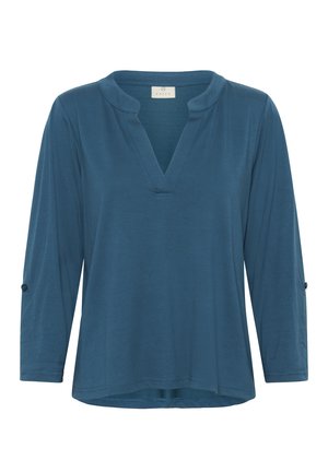 Blue, long-sleeve top with a V-neck and relaxed fit. Features roll-tab sleeves and a smooth, textured fabric. Minimalistic design.