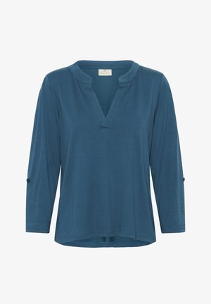 Blue, long-sleeve top with a V-neck and relaxed fit. Features roll-tab sleeves and a smooth, textured fabric. Minimalistic design.