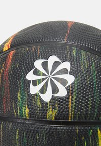 Black basketball featuring a textured surface with multicolored streaks in red, green, and yellow; a white flower emblem is centered.
