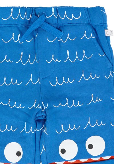 Blauwe kindershorts met witte golfpatronen, een elastische tailleband, koord, zijzakken en cartoonogen nabij de onderste zoom.